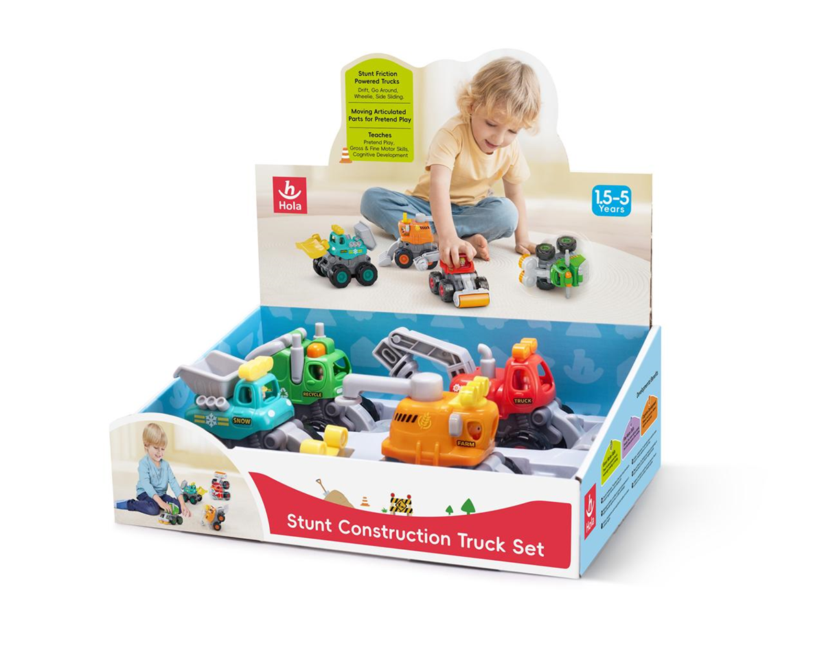 249-249069 - Da-Da Kids Colorful construction toy trucks in an open display box, with packaging reading 'Stunt Construction Truck Set' and a child playing nearby (ages 1.5–5).