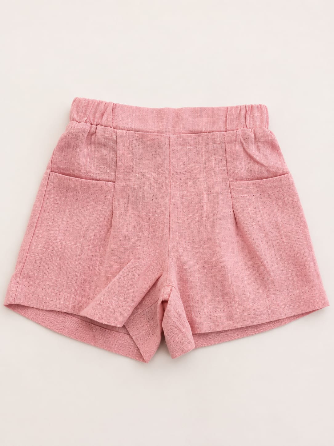 WhatsApp Image 2026-07-27 at 105102 - Da-Da Kids Pink shorts with an elastic waistband and two front pockets, lightweight fabric texture visible.