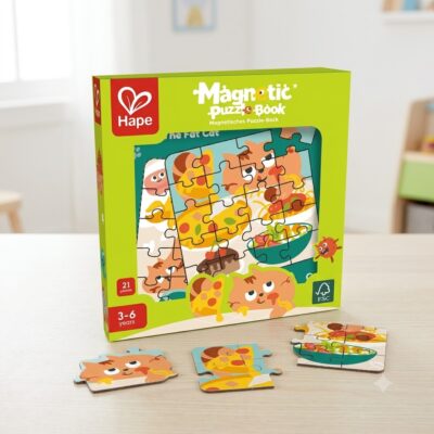 Green Hape Magnetic Puzzle-Book box on a table with scattered puzzle pieces.